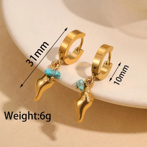 Detail of 18K gold hoop earrings with turquoise stone and seashell pendant charms