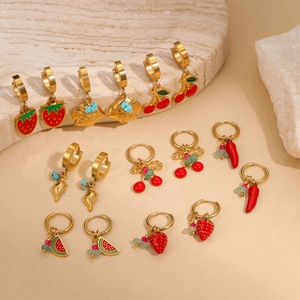 Close-up of 7 pairs of gold-plated summer fruit earrings with enamel charms