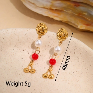 Detail shot of gold cherry earrings with rose motif and pearl accents, length 48mm