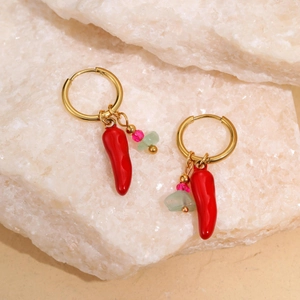 Detail of 18k gold hoop earrings featuring red chili, pink bead, and green stone charms