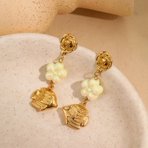 Golden flower and fish drop earrings with pearlized floral bead in a ceramic plate