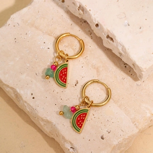 Detail of 18k gold cherry watermelon drop earrings on natural stone background