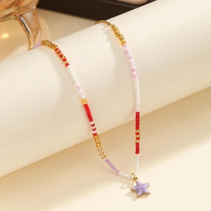 Macro detail of Bohemian colorful beaded necklace with a purple starfish pendant charm