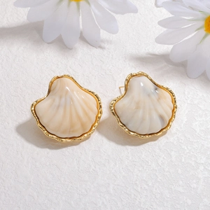 Vintage seashell stud earrings with gold plating and cream shell texture in natural light