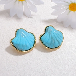 Blue seashell stud earrings with 18K gold edges and marble texture on white background