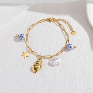 Golden stainless steel ocean bracelet with starfish, seashell, and ceramic bead charms