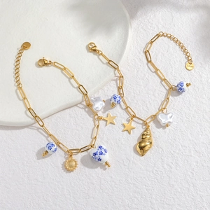 Blue and white porcelain bead bracelets with 18k gold shells and steel charms