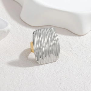 Irregular geometric two-tone stainless steel ring with textured silver wavy surface