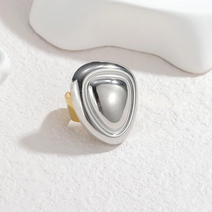 Detail of two-tone stainless steel ring with polished silver shield and gold band