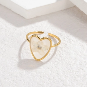 18k gold plated open ring with heart shaped blue dried flower in minimalist aesthetic