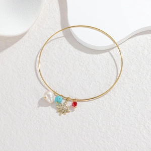 18K gold plated stainless steel bangle featuring star charms and natural pearl pendants