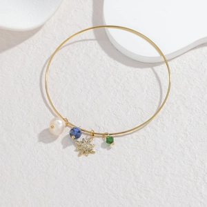 18K gold plated stainless steel bangle with pearl, star, and gemstone charms