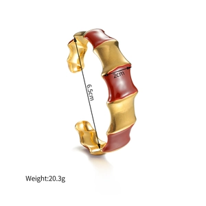 Bamboo style gold plated stainless steel open bangle with deep red enamel accents