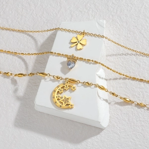 Layered 18k gold plated necklaces featuring clover, heart, and crescent moon charms