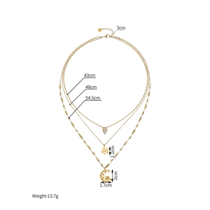 Three-layered 18k gold plated necklace with clover, moon, and heart pendants on white background