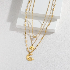 Three-layer 18k gold plated necklace featuring clover, heart crown, and crescent moon charms