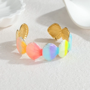 Close-up of golden starfish cuff bracelet with colorful rainbow enamel shells