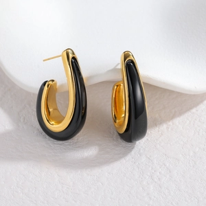 Modern hollow teardrop earrings in gold metal with black enamel finish for women
