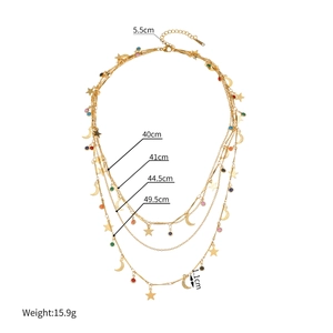 Multi-layer gold necklace with star moon pendants and colorful beads on white background