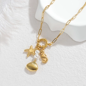 Golden stainless steel ocean charm necklace with starfish, seashell and pearl accents