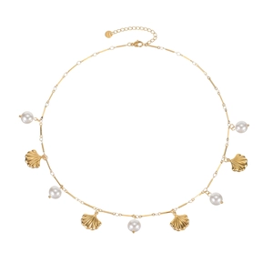 Vintage gold necklace featuring sea shells and white pearl pendants on a white background