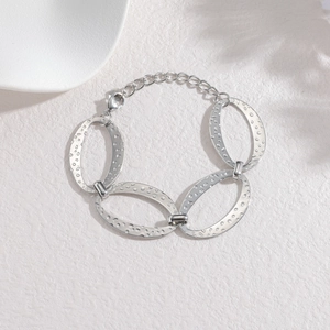 Silver stainless steel bracelet featuring four large hammered oval links and lobster clasp