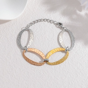 Three-tone stainless steel oval link bracelet with hammered texture and lobster clasp