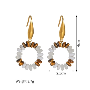 Detail view of Bohemian beaded drop earrings with golden hooks and vintage stone beads