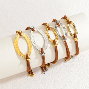 Set of 5 geometric bangles with gold and silver links on brown suede cords