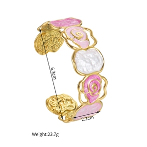 Detail view of gold floral cuff bracelet with pink marble enamel and dimension specs