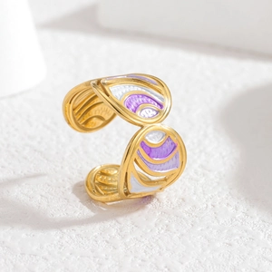 Detailed macro of golden butterfly ring with purple enamel inlay and adjustable band