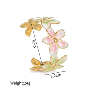 Detail view of gold floral bangle with dimensions 6cm diameter and 24g weight