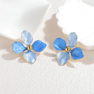 Elegant blue floral earrings with 18k gold center on a clean white background