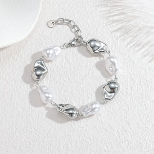 Baroque pearl bracelet with irregular silver stainless steel elements on white background