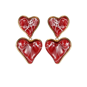 Elegant gold-plated heart drop earrings with red glazed enamel and abstract white detailing