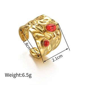 Macro shot of 18k gold irregular hammered texture ring with red turquoise inlay details