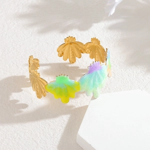Gold stainless steel open bangle with colorful enamel flower petals on white background