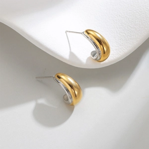 Minimalist C-shaped geometric hoop earrings in polished gold and silver dual-tone finish
