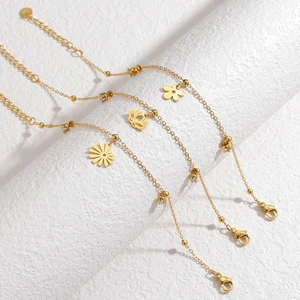 Three-piece gold stainless steel bracelet set with floral charms and crystals