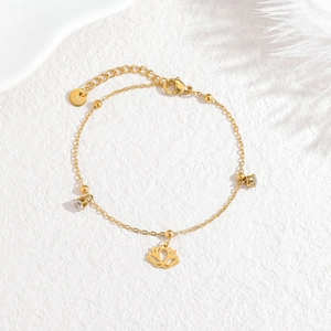 Elegant 18k gold lotus bracelet with sparkling zircon stones on a white background