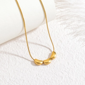 Minimalist gold snake chain necklace featuring three satin finish bean-shaped pendants