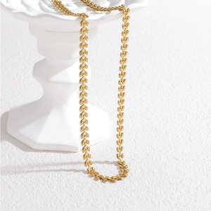 18k gold plated stainless steel wheat ear necklace draped on white stone stand