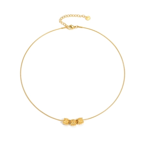 Minimalist gold necklace with three floral pendants on a sleek snake chain and lobster clasp