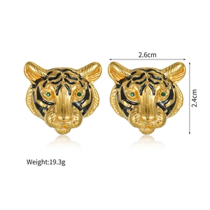 Detailed tiger head earrings in gold finish with black enamel and green gemstone eyes