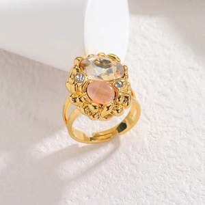 Adjustable golden ring featuring amber faceted stone and pink opal effect gem on textured base
