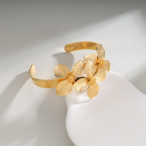 Vintage gold stainless steel open cuff bracelet with detailed 3D floral petal texture