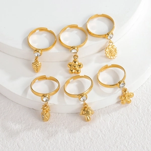 Detailed close-up of 18k gold adjustable rings with floral charms and cubic zirconia