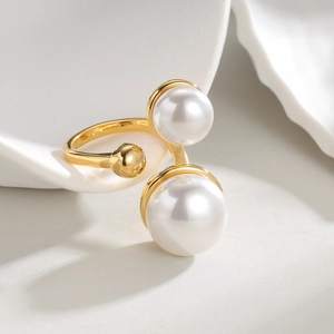 French vintage gold open ring with double pearls on white ceramic display