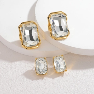 18k gold geometric square zircon earrings displayed on minimalist white stand