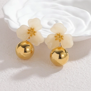 Vintage red flower earrings with elegant golden spheres on a relief porcelain plate